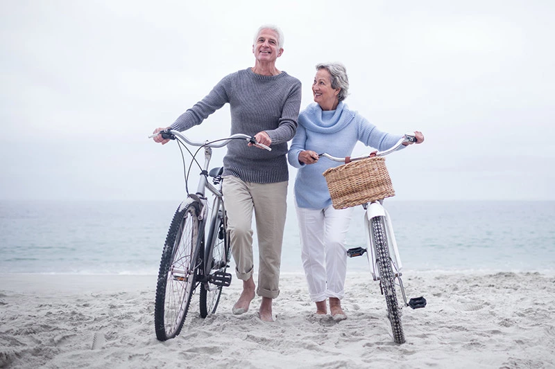 happy older couple on the beach | smart health insurance portland